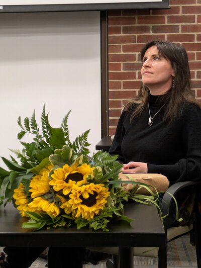 Poet and translator Oksana Maksymchuk with sunflowers