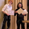 Tom Booth receiving award certificates