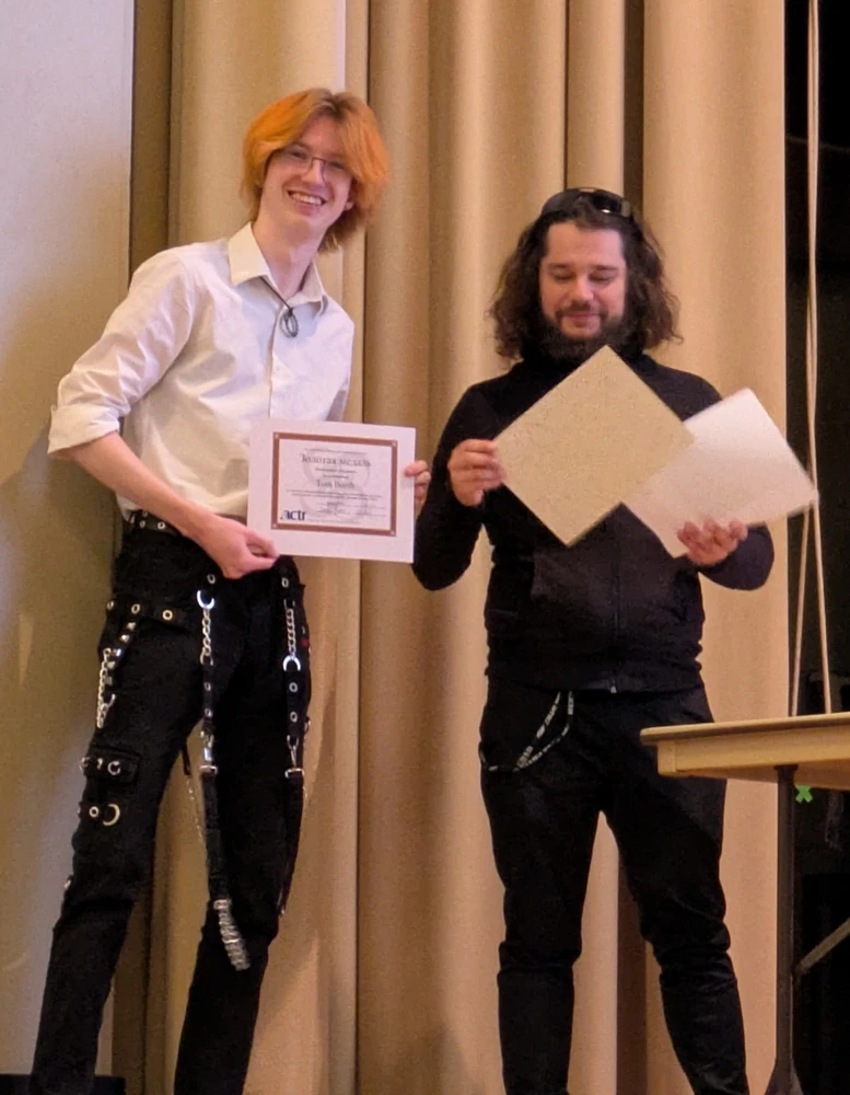 Tom Booth receiving award certificates