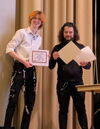 Tom Booth receiving award certificates